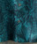 Lion Tamer, close-up image of a stylish shirt featuring a tropical leaf print in shades of teal and black, with visible buttons down the front.