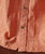 Side Effects, close-up of a peach-colored textured shirt with buttons.