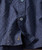 Boomerang, close-up image of a blue shirt with embroidered musical note.