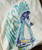 Attitude Dance, a graphic t-shirt featuring a stylized illustration of a skater playing a trumpet in vibrant blue, green, and red colors.