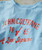 A Love Supreme, light blue T-shirt with red printed text and graphics related to jazz legend John Coltrane and his iconic album.
