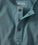 Spontaneous Simplicity, close-up of a teal button-up shirt featuring a collar and wooden buttons.