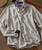 Cloudscape, a long-sleeve button-up shirt with a subtle cloud pattern in light and dark shades, featuring contrasting navy cuffs and collar details.
