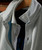 Bits Of Blues, close-up image of a stylish beige and blue textured jacket on a hanger with detailed stitching and fabric pattern.
