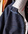 Jazz Me Blues, close-up of a denim jacket with a striped shirt layered underneath.