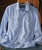 Take It To The Sky, white textured men's Western shirt with snap buttons and flap chest pockets, displayed on a hanger with a guitar in the background.