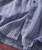 Blue Jazz, close-up of a blue and white striped men's dress shirt with buttons and cuff detail.