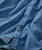 Point Made, close-up image of a denim shirt with small embroidered white dots and blue buttons.