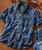 Palm Wine, traditional African-style denim shirt with palm tree embroidery.