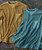 Steady Gettin' It sweatshirts, two casual fleece sweatshirts in tan and blue colors with front chest pockets, laid flat on a textured background.