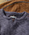 Thump And Bump, close-up of a gray, textured, long-sleeve shirt with a crew neck and buttoned placket, showcasing its cozy corduroy fabric.