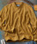 Soulshine, yellow checkered knit sweater with a ribbed V-neck and cuffs laid flat on a surface with a guitar and jeans nearby.