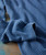 Very Yes, blue ribbed cozy sweater, close-up of soft knitted fabric with textured pattern.