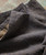 Yeah Man, close-up image of textured grey men's trousers highlighting the fabric and stitch details.