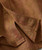 Shake My Tree, close-up of a pocket on a clothing item made of herbal botanicals-patterned fabric in shades of brown and pink.