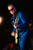 Blue Guitar Blues, male musician playing an electric guitar during a live performance.