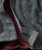 Black Diamond Bay, close-up view of a textured black and gray patterned jacket with buttons and inner lining.
