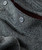 Black Diamond Bay, close-up of the textured grey fabric with buttons showcasing the outdoor jacket's detailed stitching and durable material.