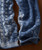 Drifting Blues, pairs of blue textured knit socks with cable patterns and ribbed cuffs.