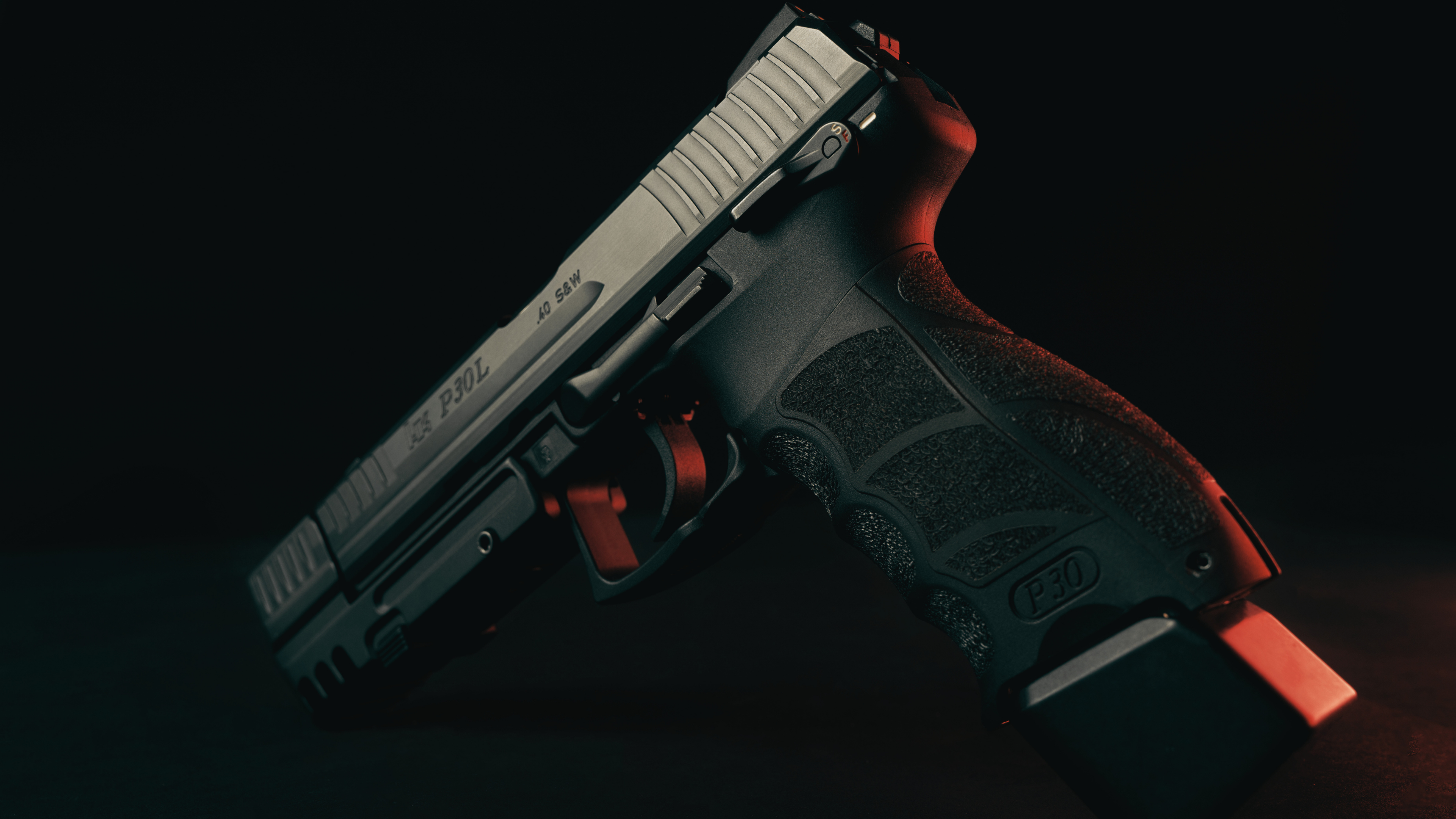 H&K firearm on a charcoal tactical background