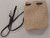 Purse shown lying flat on Table with strap.