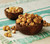 Profile view of Macadamia CaramelCrisp in a coconut-shaped bowl