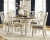 Ashley Realyn Chipped White 7-Piece Dining Set with Rectangular Table and 6 Ladderback Chairs