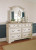 Ashley Realyn Chipped White California King Sleigh Bed with Mirrored Dresser and Chest