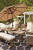 Ashley Beachcroft Beige Outdoor Dining Table and 4 Chairs and Bench