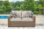 Ashley Beachcroft Beige Outdoor Loveseat with Cushion