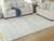 Ashley Genemost Ivory Blue 7'8" x 10' Area Rug