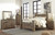 Ashley Trinell Brown Queen Poster Bed