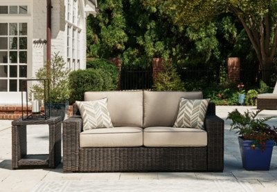 Ashley Coastline Bay Brown Outdoor Loveseat with Cushion