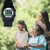 Close-up view of black WobL+ watch; photo of grandmother in wheelchair, daughter, and granddaughter.
