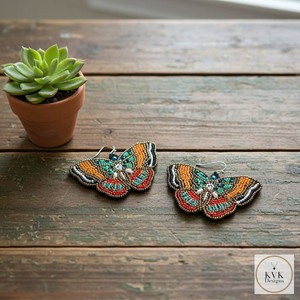 Beaded Butterfly Earrings laying on distressed farm table