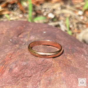 3mm Copper Band Ring sitting on a rock