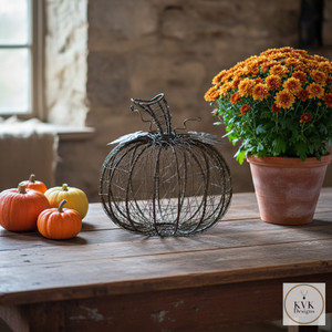 Wire Wrapped Fall Pumpkin sitting on an antique farm table Wire Wrapped Fall Pumpkin sitting on an antique farm table