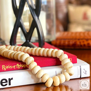 Oversized Hand Carved Bone Beads from Kenya - Sitting on Book