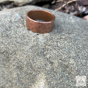 8mm Hammered Copper Band Ring sitting on a stone 8mm Hammered Copper Band Ring sitting on a stone