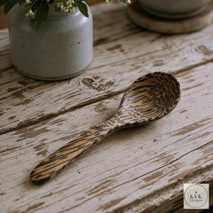 Eco-Friendly Palm Wood Coffee Scoop sitting on antique farm table