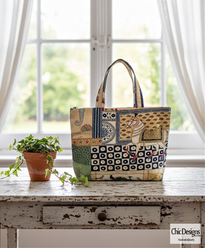Animal and Floral Print Tote Bag sitting on a white distressed table