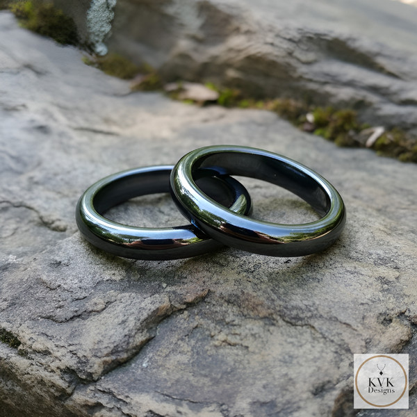 4mm Magnetic Hematite Dome Ring sitting on rocks outside