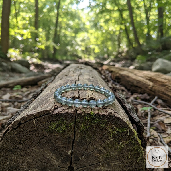 Labradorite Stretch Bracelet sitting on a log in the woods