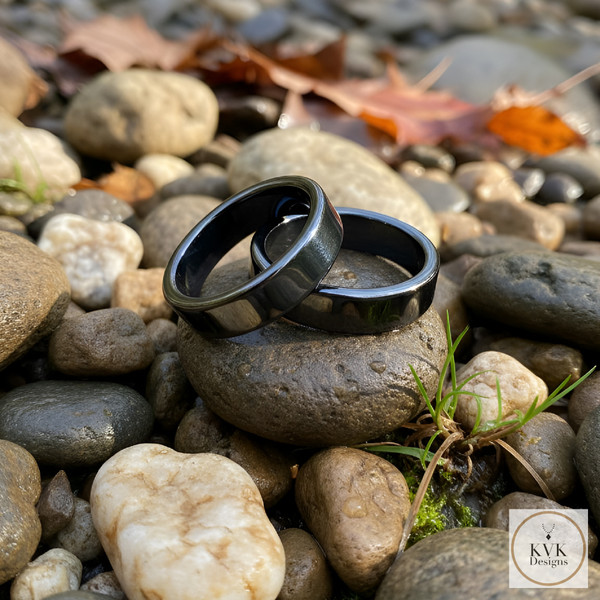 6mm Flat Hematite Rings sitting on rocks outside