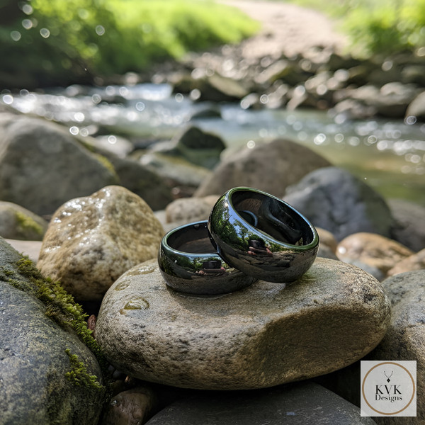 10mm Magnetic Hematite Dome Rings sitting on rocks outside