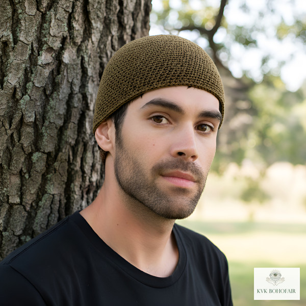 Model wearing Mocha Brown Kufi Skull Cap standing against a tree Model wearing Mocha Brown Kufi Skull Cap standing against a tree