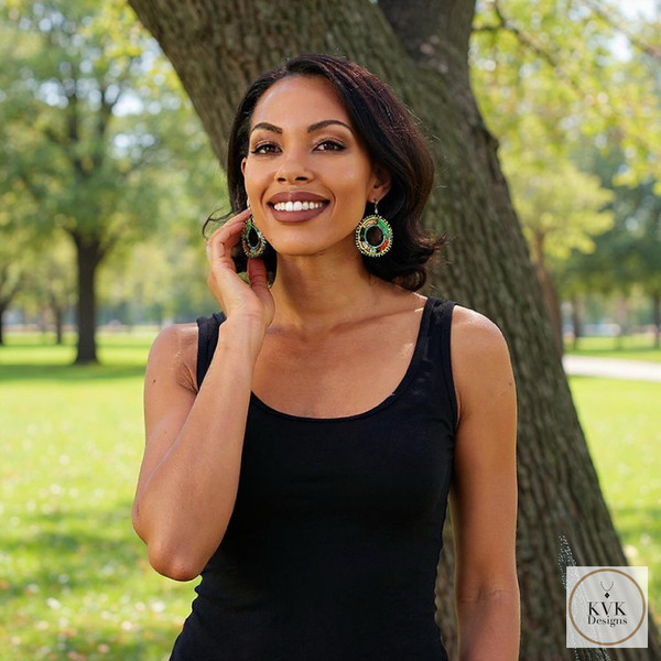 Colorful Round Maasai Beaded Earrings worn by our model who is standing in front of a tree