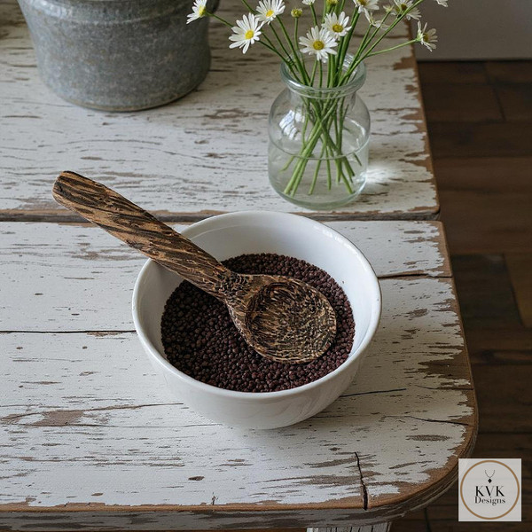 Eco-Friendly Palm Wood Coffee Scoop sitting on an antique farm table sitting in a bowl of coffee grounds