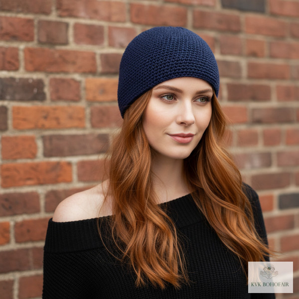 Model wearing navy blue kufi skull cap against a brick wall Model wearing navy blue kufi skull cap against a brick wall