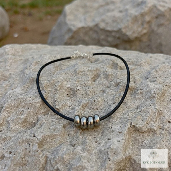 Boho Silver Bead Choker Necklace sitting on a rock